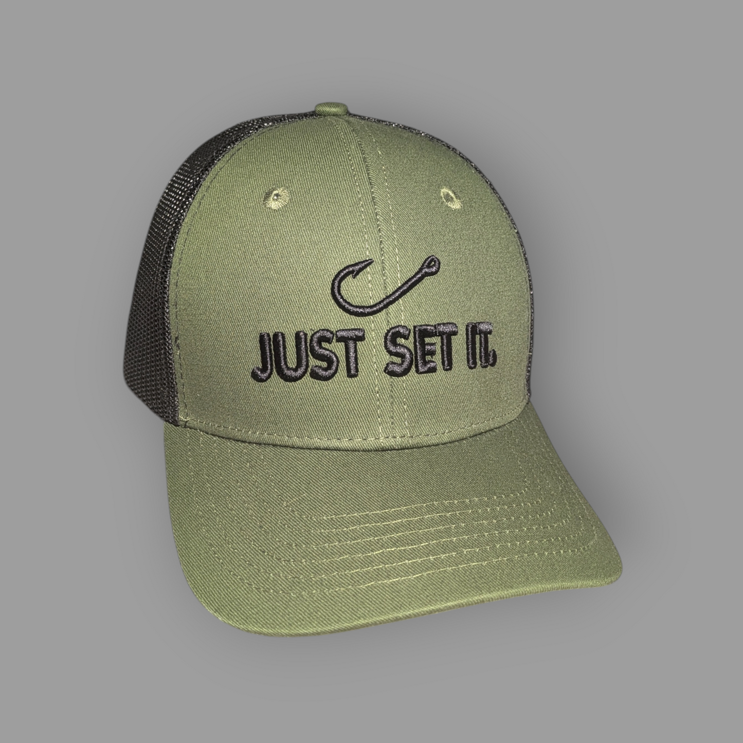 Green cap with 'Just Set It' text and fish hook symbol on a gray background