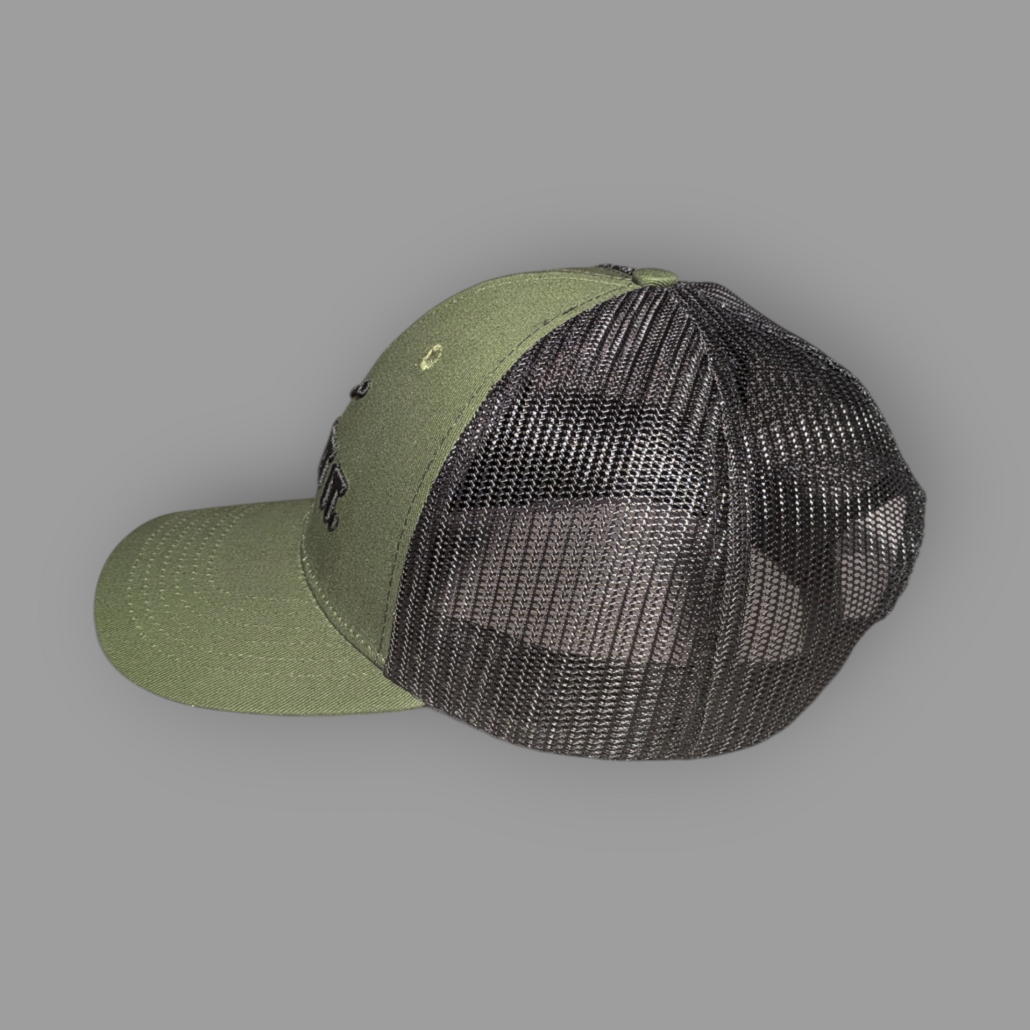 Green cap with black mesh back on a gray background