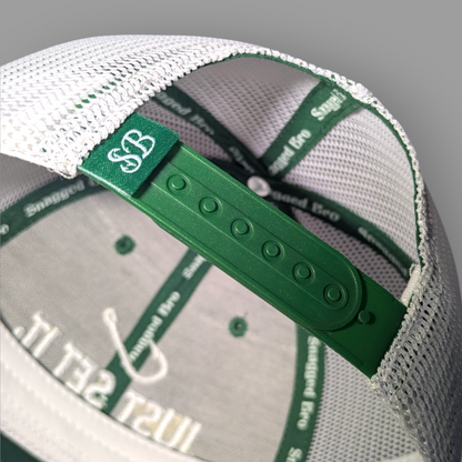 Trucker hat with green and white design on a gray background