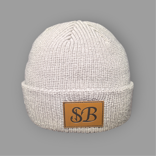 White knit beanie with a brown leather patch featuring 'SB' on a gray background