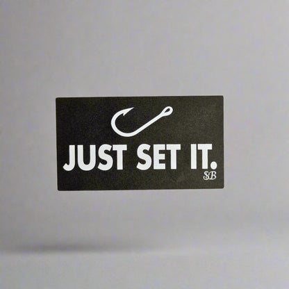 Black and white sticker with 'JUST SET IT.' text on a light gray background