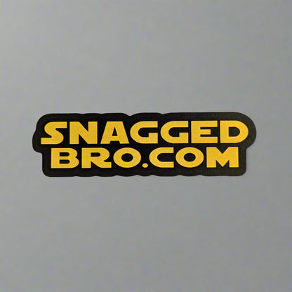 Sticker with 'Snagged Bro.com' text on a light gray background, in star wars style writing.