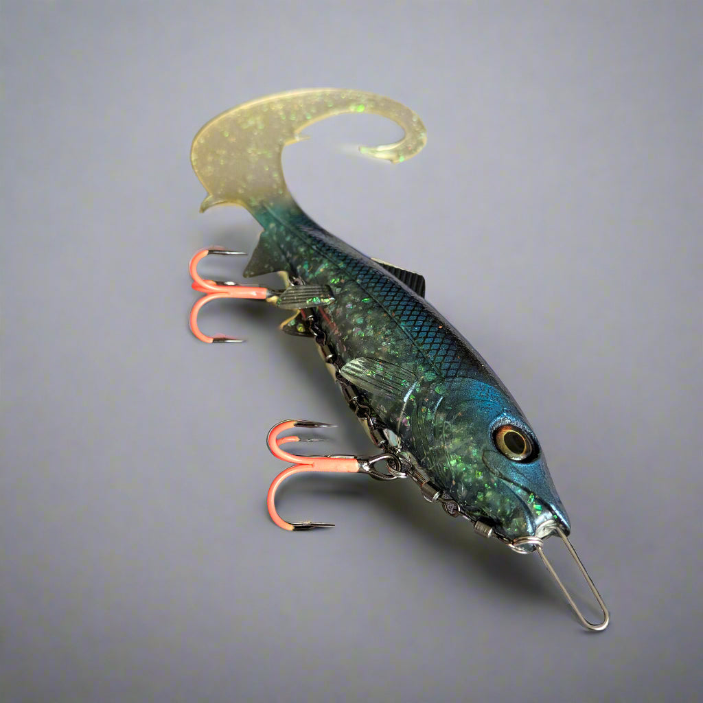 Fishing lure with UV hooks on a gray surface