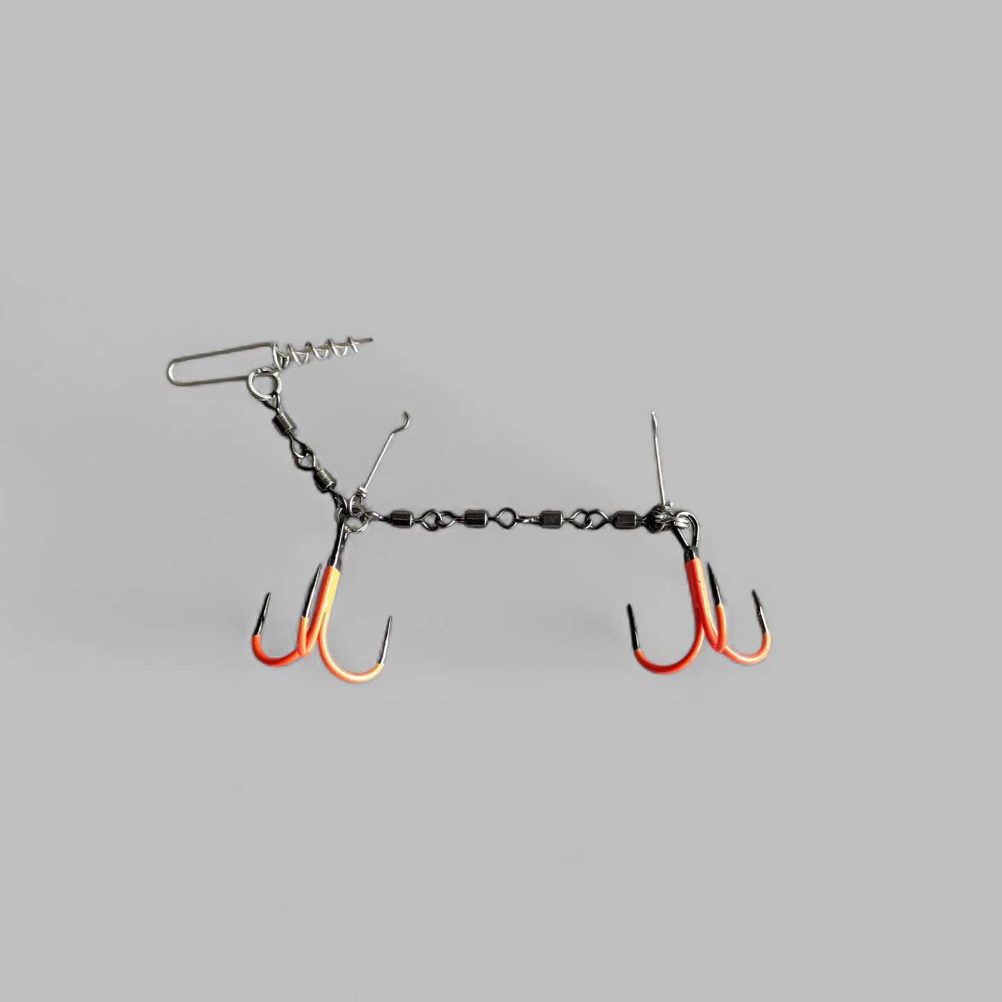 Fishing rig with two orange UV hooks on a grey background
